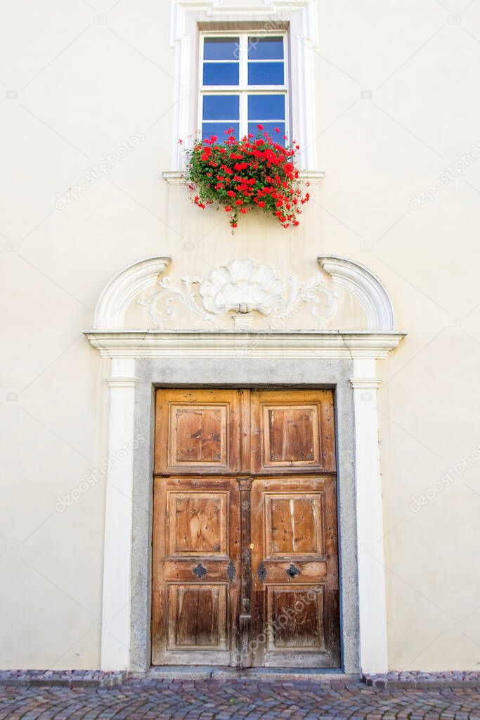 entrance of the ancient building of the abbey of novacella, in italy, tyrol, historic alpine monastery, with beautiful vineyards, wine producer