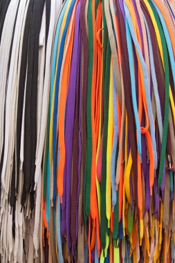 Collection of many colorful shoelaces at a retail stand clipart