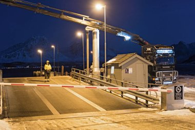 BREIVIKEIDET, NORWAY-JANUARY 16, 2018: Driveway to the car ferry in Breivikeidet, Norway clipart