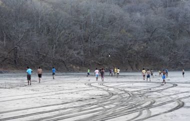 Playa De Coco, Kosta Rika-Mart 09, 2017: Playa del Coco, Guanacaste Eyaleti, Kosta Rika, sahilinde gençler oynarken futbol
