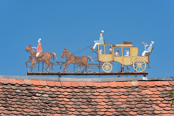 Metal figures stagecoach on the roof of a estate