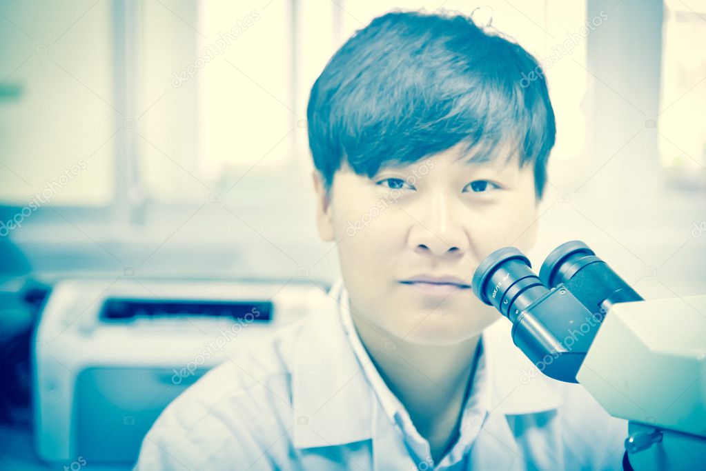 asia scientist working in biological laboratory.