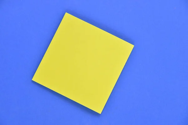 Folha de papel isolada em azul — Fotografia de Stock