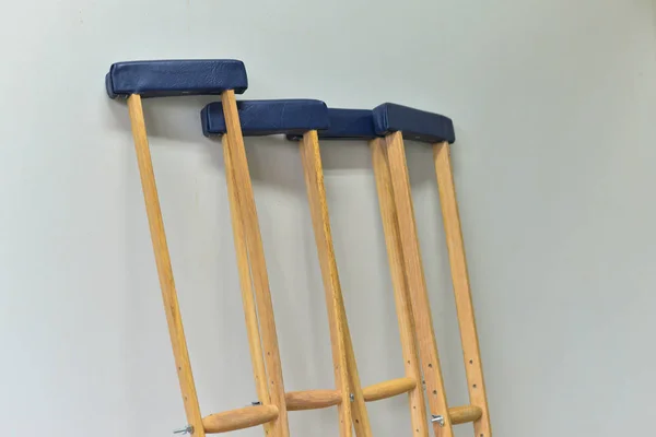 Crutches on white wall background. — Stock Photo, Image