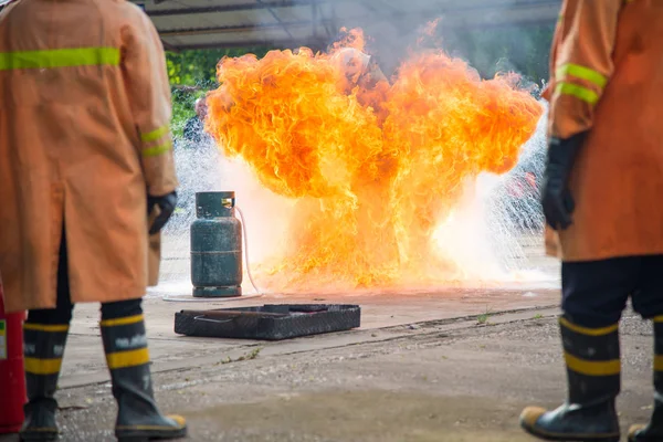 Firefighters training with fire outdoor Stock Picture