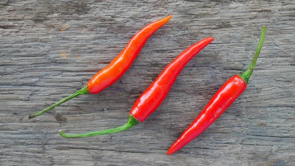 Fresh red chili on wood texture. — Stock Photo, Image