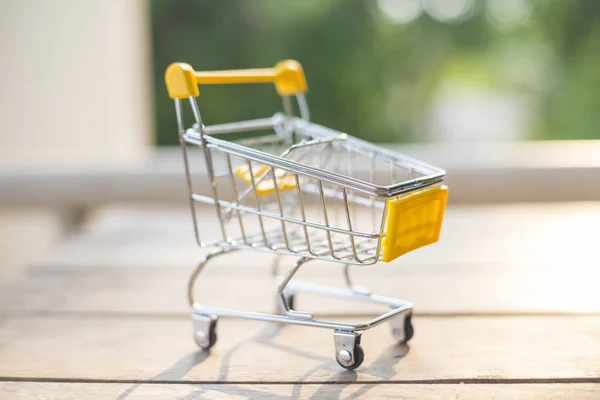 Yellow cart on wood texture.