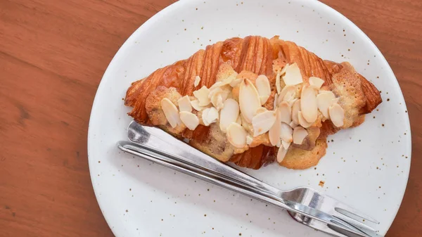 Freshly baked croissants on white plate, top view — ストック写真