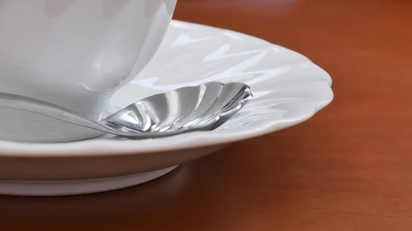 White cup and spoon on wood table. — 스톡 사진