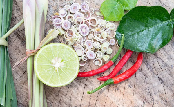 Red chilli lemongrass and green lemon on wooden cutting board. Royalty Free Stock Images