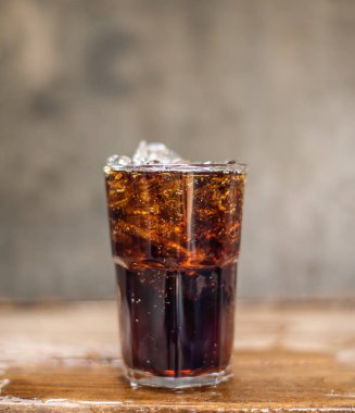 Soft drink splashing on wood table.