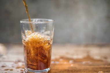 Soft drink splashing on wood table.