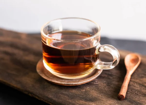 Hot tea with spoon wood on woo table. — ストック写真