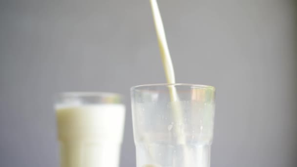 Verser le lait dans du verre sur fond flou .