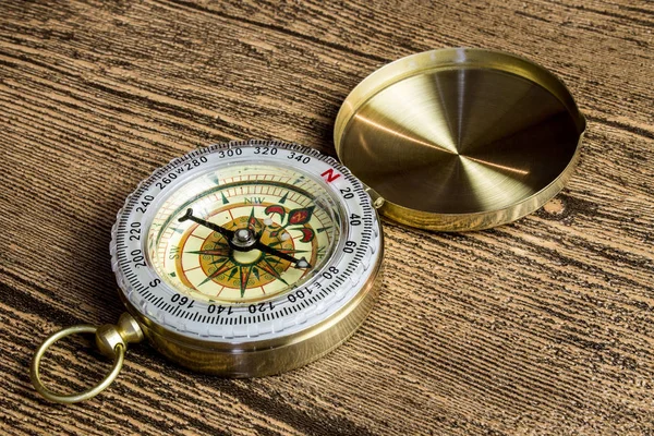 Old compass on wooden background — Stock Photo, Image