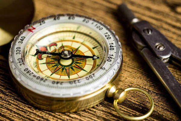 Tourist compas and circinus on wooden table — Stock Photo, Image