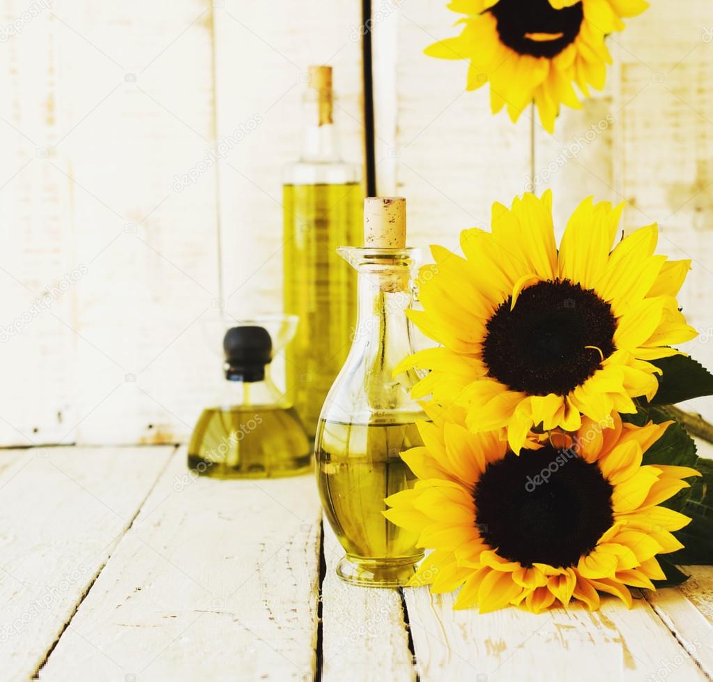 Bottle with oil flowers sunflower, selective focus