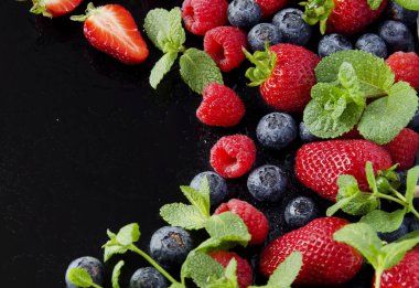 Olgun Kırmızı Ahududu ve çilek ahşap kase, seçici odak