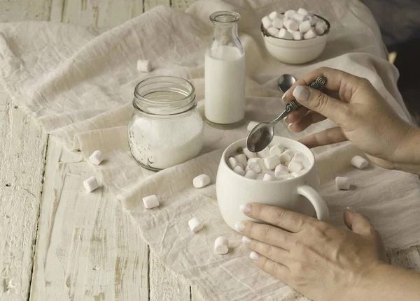 white cup with cocoa and marshmallows, selective focus