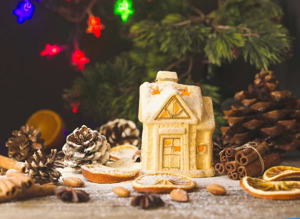 Christmas card with little toy house and decorations on a wooden rustic table, selective focus — Stock Photo, Image