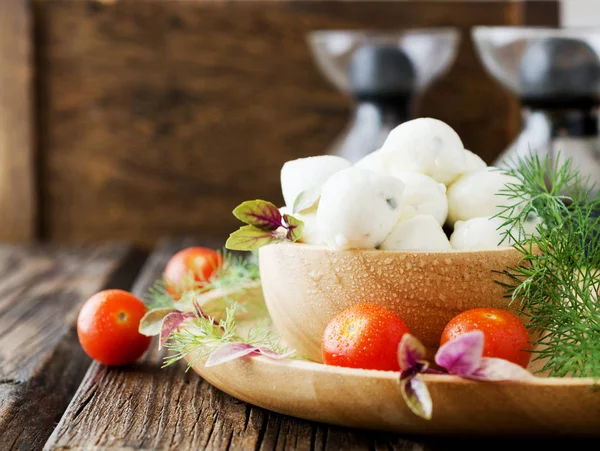 Beads of mozzarella cheese, with greens and tomatoes, selective focus — Stock Photo, Image