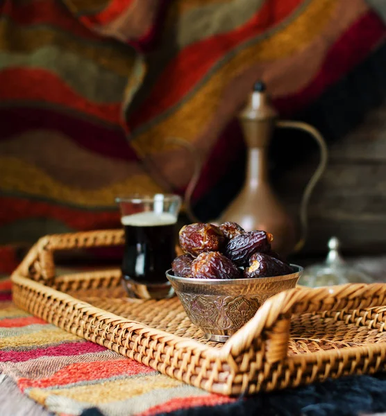 Eid mubarak with arabic coffee pot and dates. Dried dates and coffe