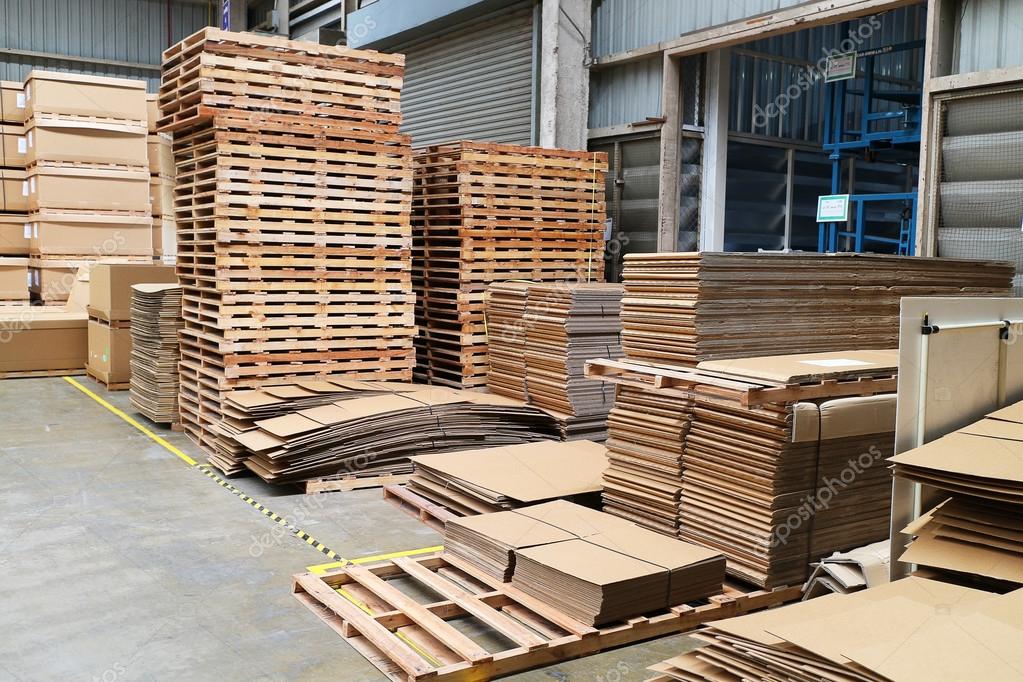 Wood pallet and paper boxes in factory warehouse. Stock Editorial
