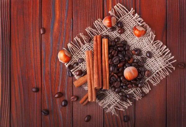 Coffee beans, hazelnut and cinnamon — Stock Photo, Image