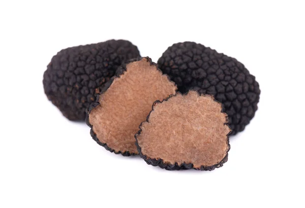 Black truffles isolated on a white background. Fresh sliced truffle. Delicacy exclusive truffle mushroom. Piquant and fragrant French delicacy. Clipping path. — Stock Photo, Image