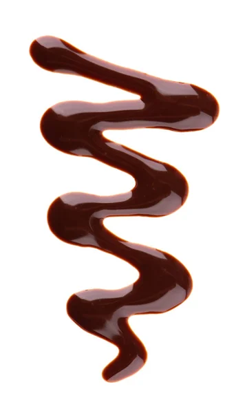 Gotejamento de xarope de chocolate isolado no fundo branco. Salpicos de molho de chocolate doce. Vista superior. — Fotografia de Stock