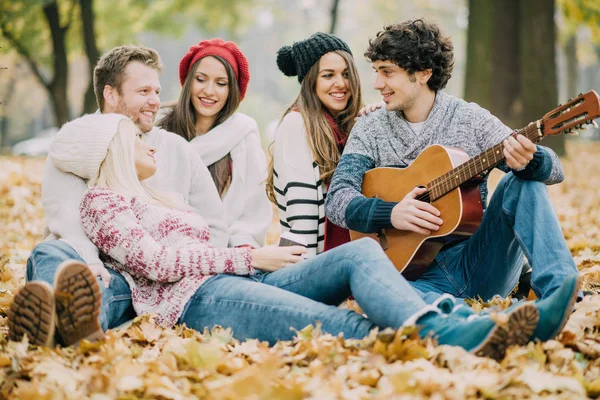 Vrienden gitaarspelen buiten — Stockfoto