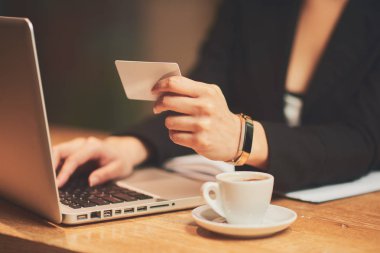 Young woman using credit card