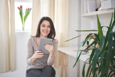 genç kadın tablet kullanarak okuma  