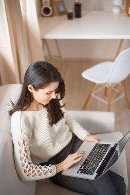 Evde çalışan genç bir kadın. 