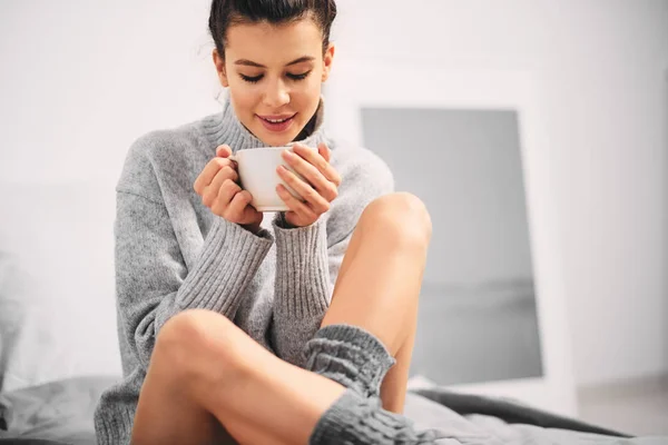 Frau Trinkt Kaffee Während Sie Morgens Auf Dem Bett Sitzt — Stockfoto