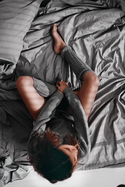 Aerial view of woman sitting on bed in the morning — Stock Photo, Image