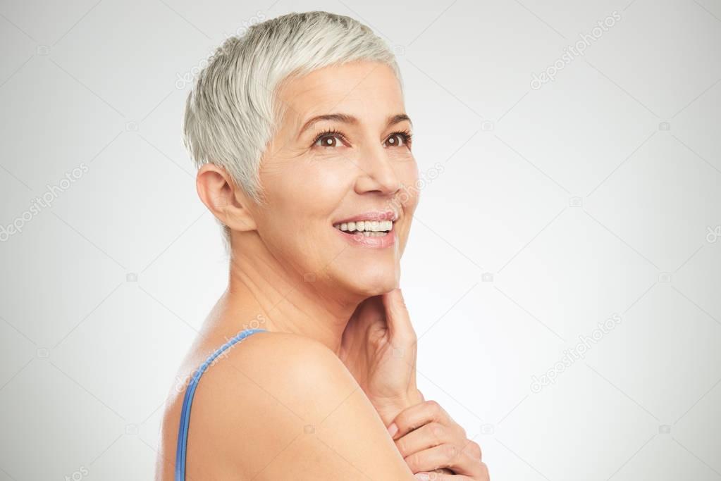 Portrait of beautiful senior woman in front of white background.