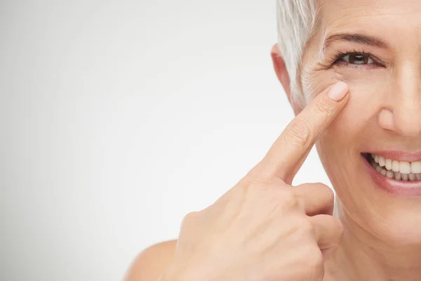 Primer plano de la mujer mayor mostrando arrugas . — Foto de Stock