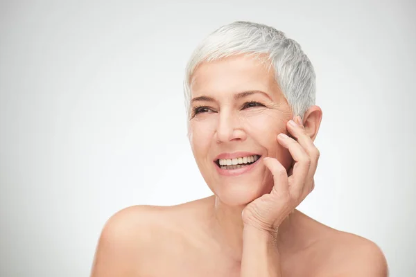 Portrait of beautiful senior woman in front of white background. — Stock Photo, Image