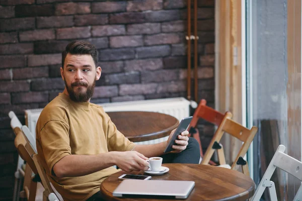 young handsome bearded man in cafe