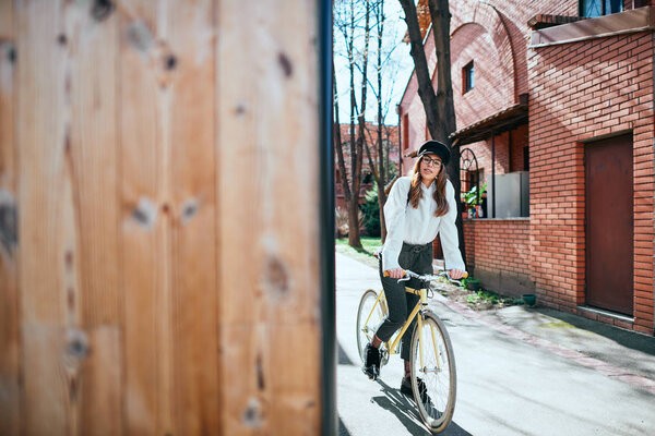 Portrait of beautiful brunette on her fixie bicycle.