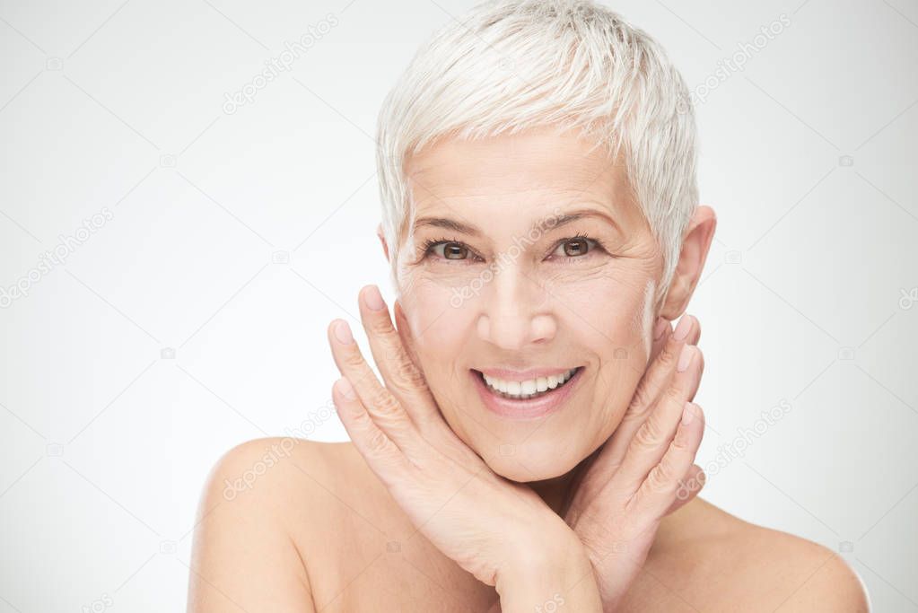 Portrait of beautiful senior woman in front of white background.