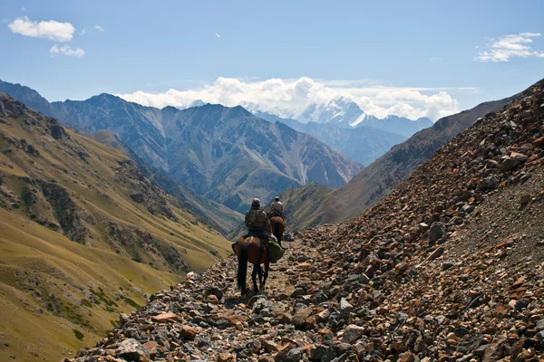 Hunters on horseback riding in the mountains of Tien Shan — Stock Photo, Image