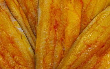 Cold smoked fish with pepper and drops of fat.