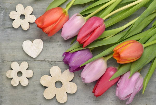 Wooden grey empty copy space background with fresh colourful spring tulips. Orange, red,pink and purple tulips. — Stock Photo, Image