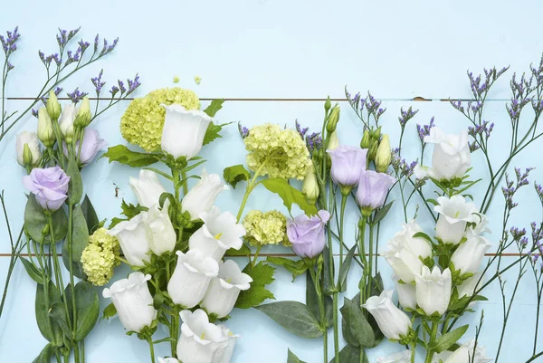 Vintage aqua green blue background with white purple lilac and yellow field flowers with empty copy space