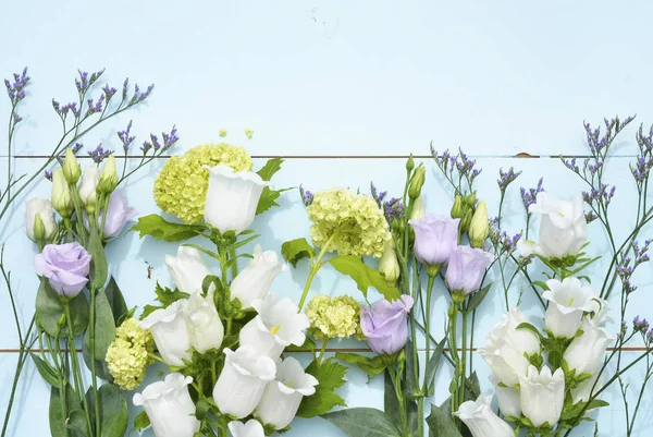 Vintage aqua green blue background with white purple lilac and yellow field flowers with empty copy space