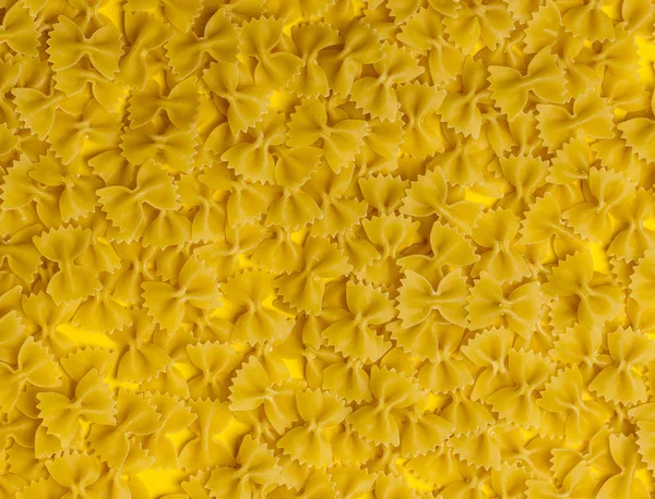 Farfalle come texture. Pasta gialla — Foto Stock