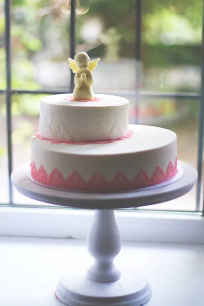 Chocolate angel on a white cake — Stock Photo, Image