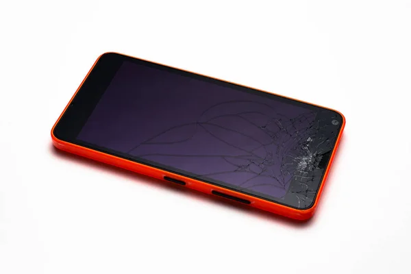 Orange smartphone with a damaged screen isolated on white background